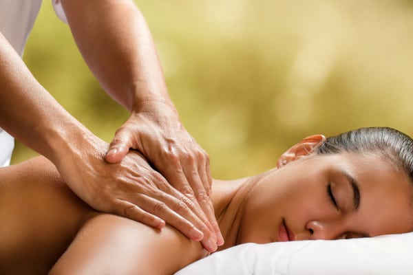 A masseur performing a massage therapy to a lady