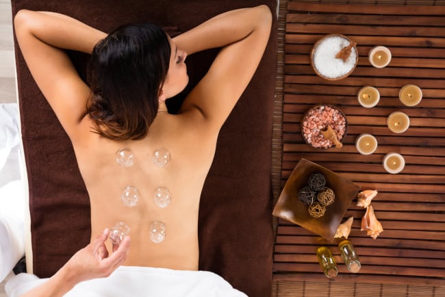 AA woman taking a nap while having a cupping therapy