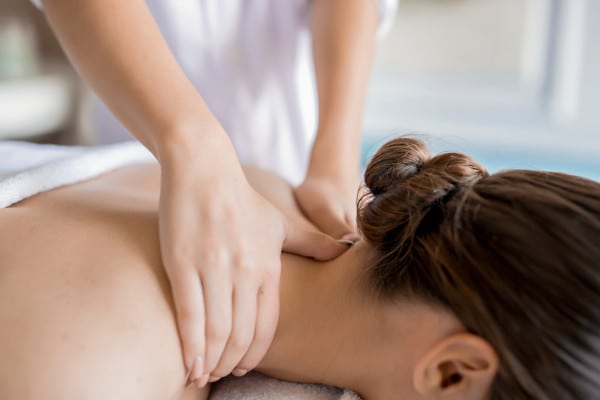 A woman having a Deep tissue massage therapy at the back of her neck