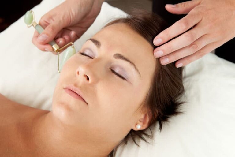 A woman having a stone facial massage