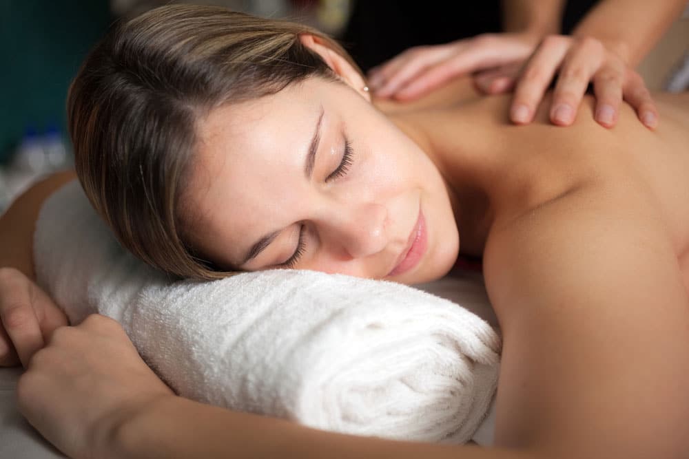 A woman laying and having Swedish massage